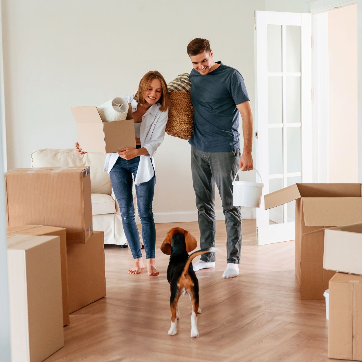 Woman and man with moving boxes and a dog