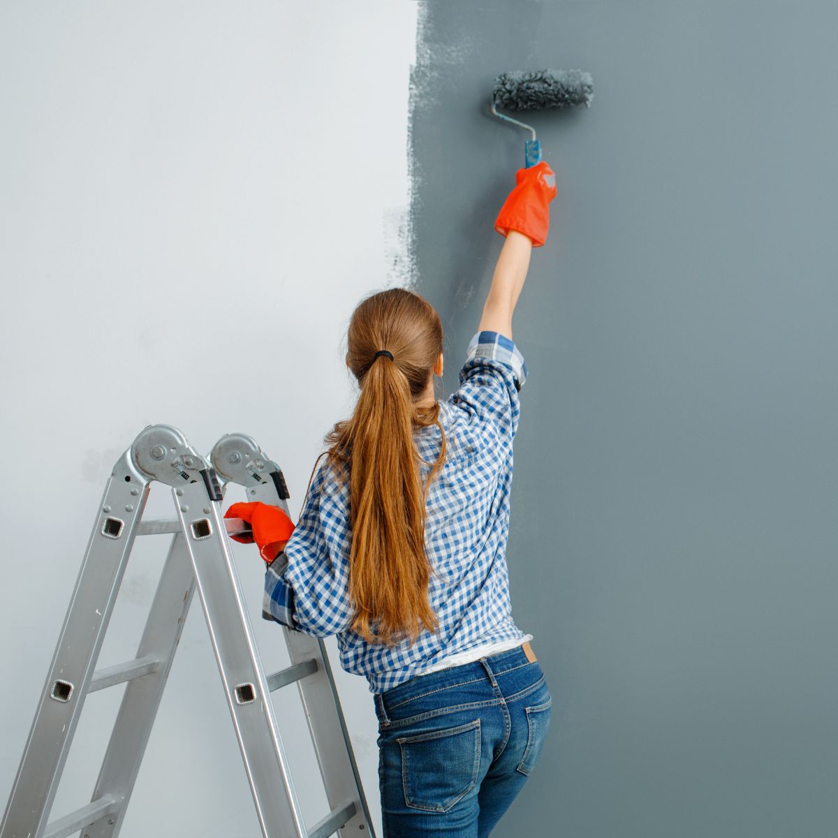 Woman painting a wall
